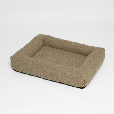 Karla orthopedic dog bed in oat bouclé with a low bolster edge