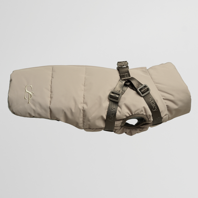 Vera quilted dog coat in sand with a built-in harness, side view