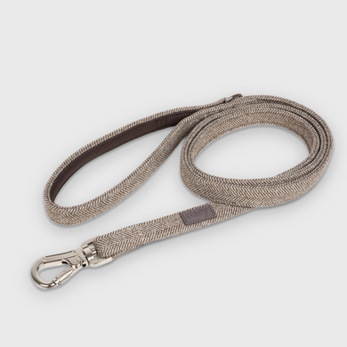 Elma dog leash in mocca herringbone, coiled with a steel snap hook