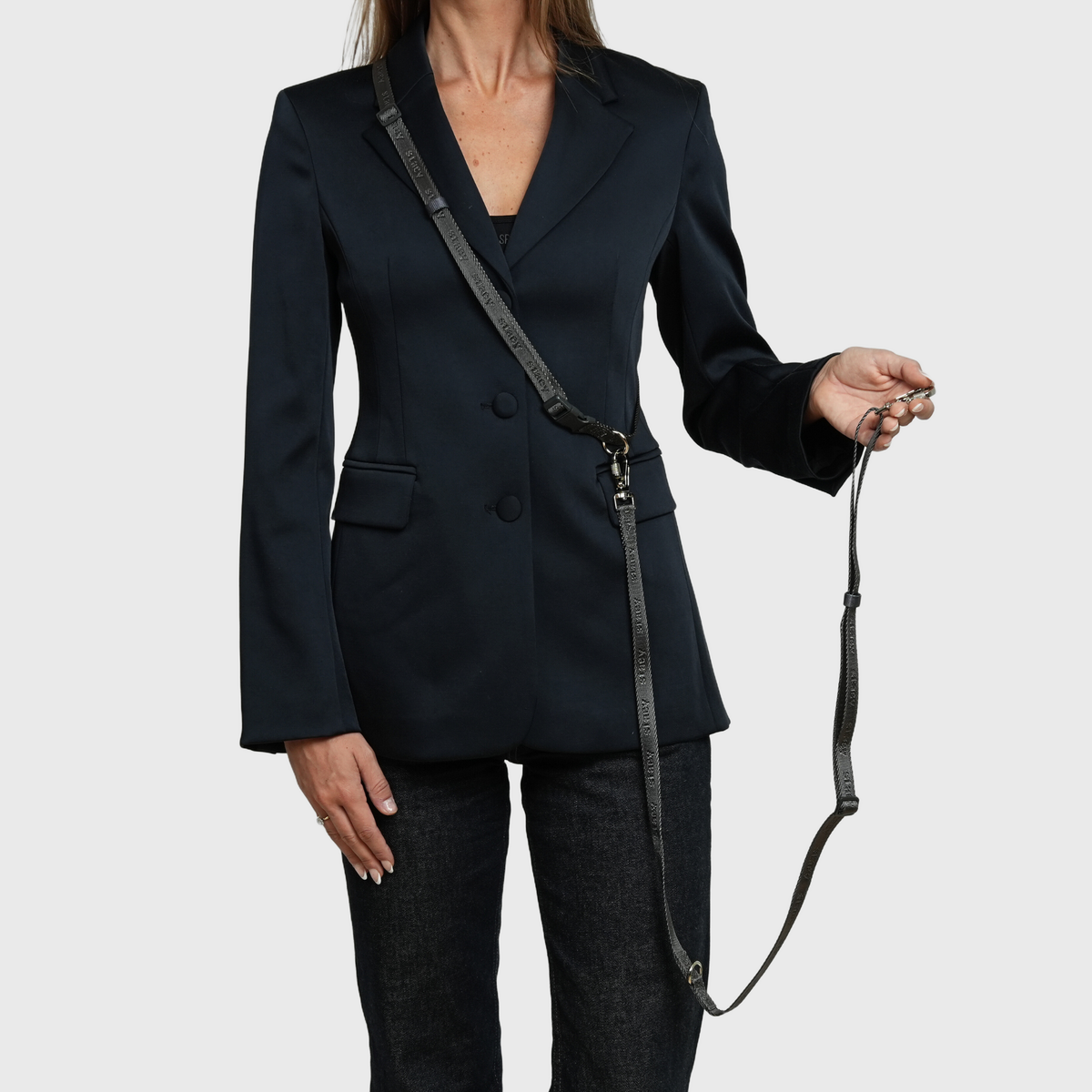 Woman holding the handle of the dusty blue hands-free leash